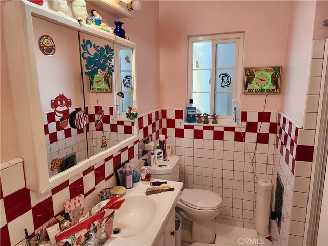 a bathroom with a toilet sink and mirror