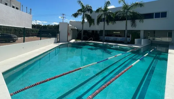 a swimming pool with outdoor seating and yard