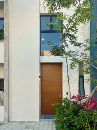 view of a house with a potted plant