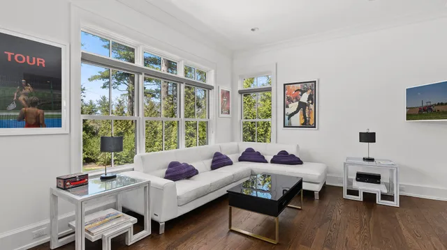 a living room with furniture and floor to ceiling windows