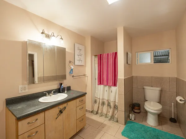 a bathroom with a sink toilet and shower