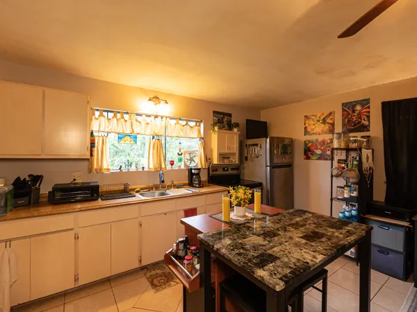 a kitchen with a table and chairs in it