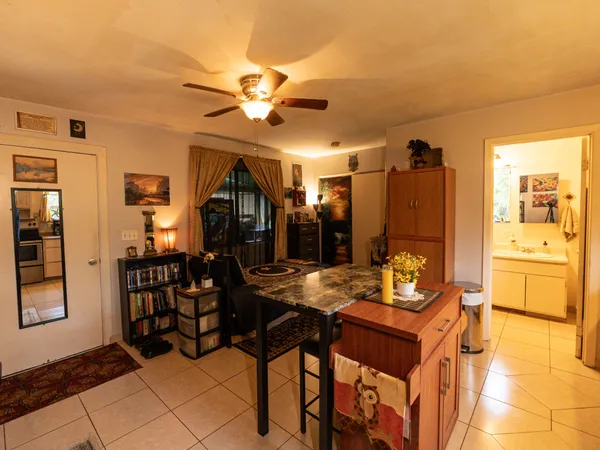 a view of a dining room with furniture and chandelier