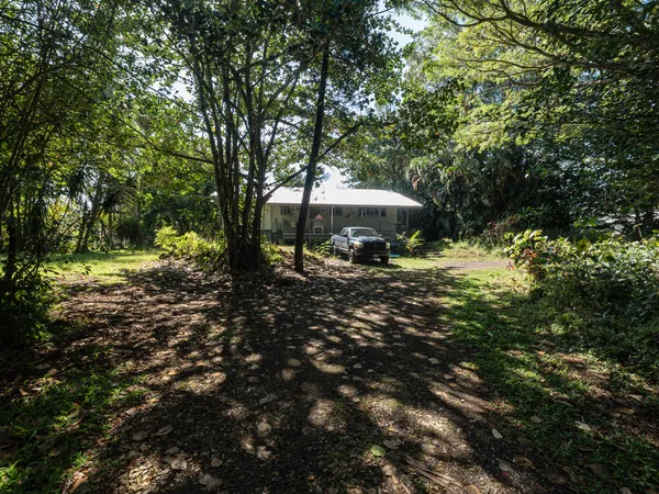 a backyard of a house with barbeque oven basket ball court and outdoor seating