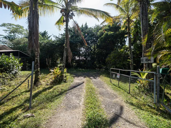 a backyard of a house with table and chairs under an umbrella