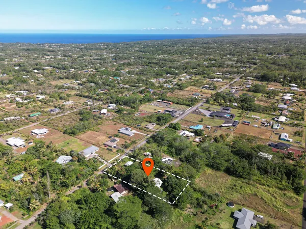 an aerial view of residential building with an outdoor space and garden