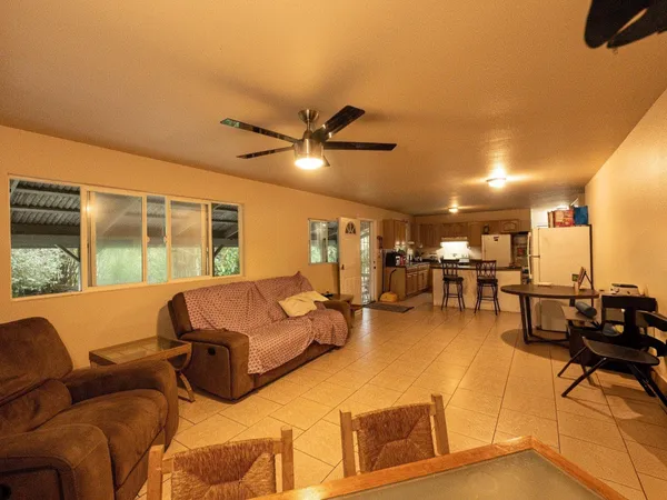 a living room with furniture and kitchen view