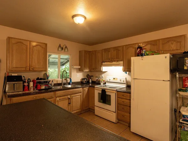 a kitchen with a sink a stove and refrigerator