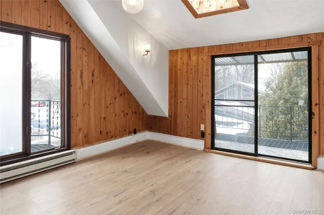 an empty room with windows and closet