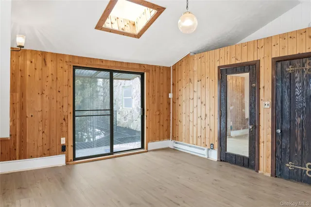 a view of a hallway with wooden floor and entryway