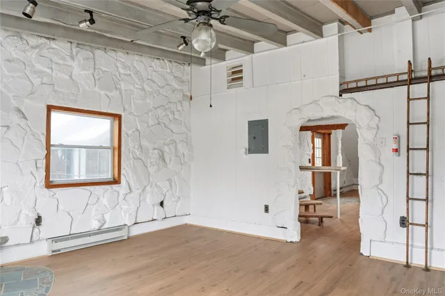 a view of a fireplace and window in a room