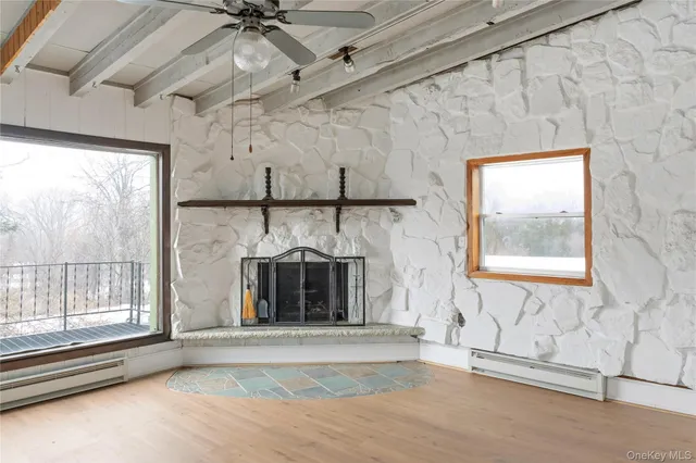 a kitchen with a sink stainless steel appliances cabinets and a large window