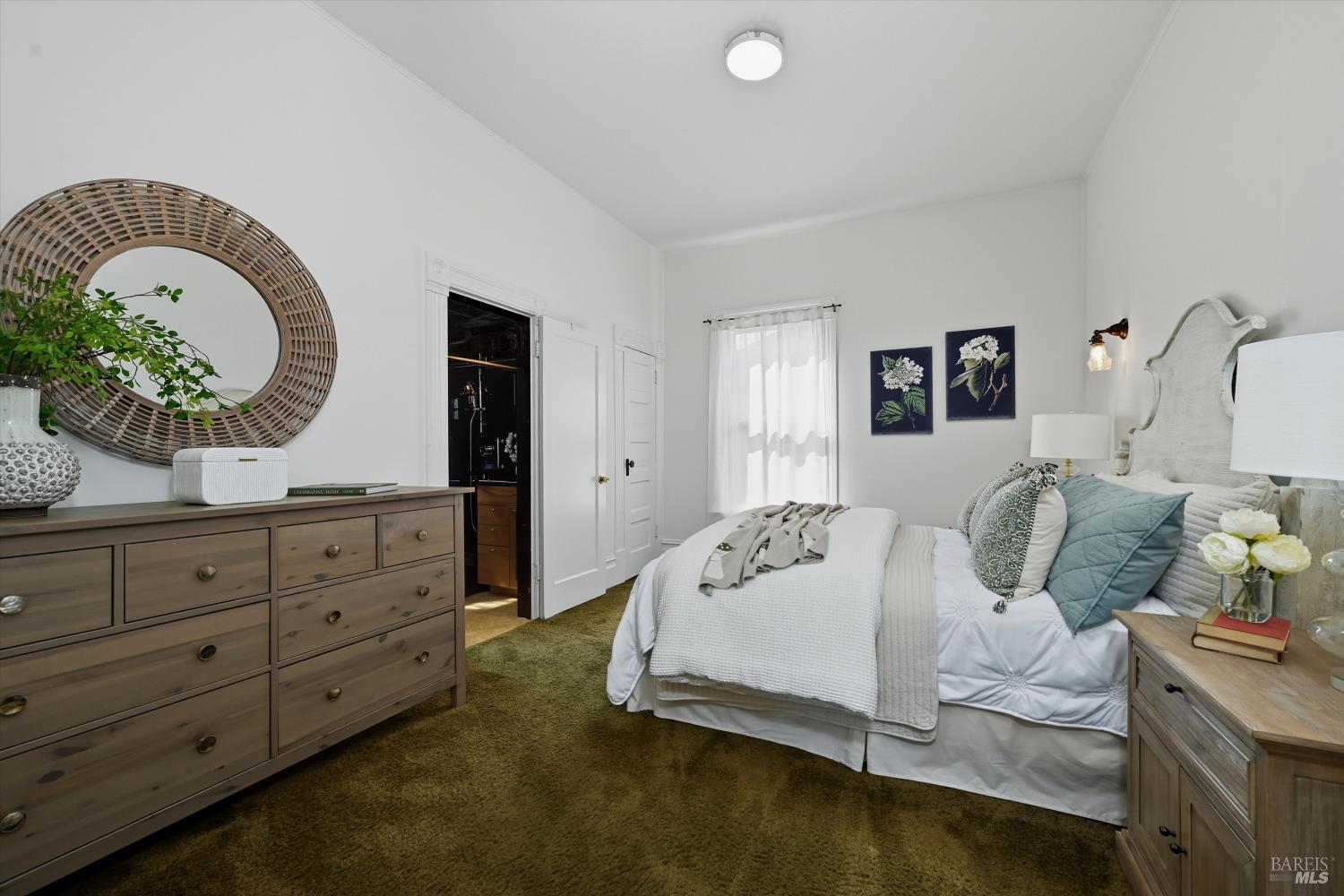 722 Beaver Street Santa Rosa, CA 95404 - Photo 11 of 29 a bedroom with a bed and a potted plant on dresser