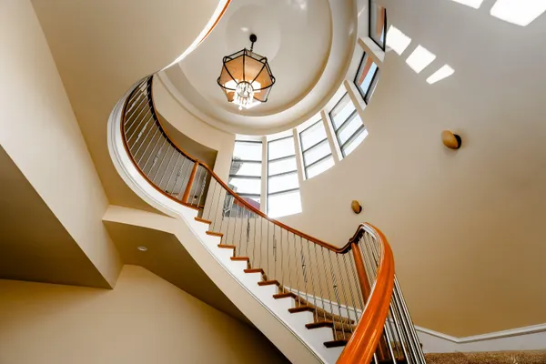 a view of staircase with railing and white walls