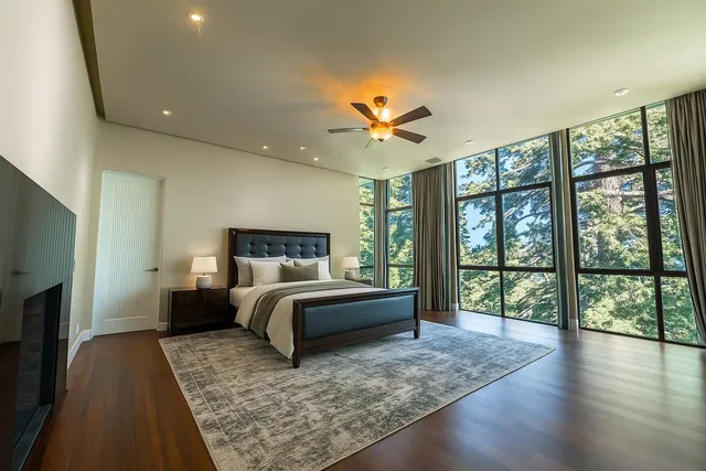 a spacious bedroom with a large bed and a large window