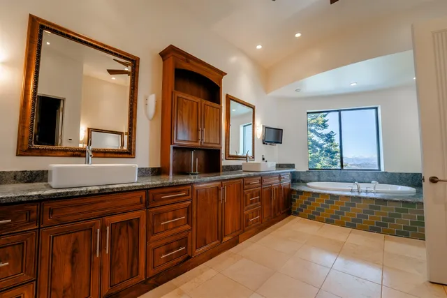a large bathroom with a large tub and sink