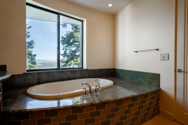 a bath tub sitting next to a window