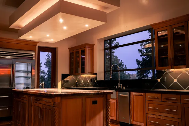 a kitchen with granite countertop a stove and a sink