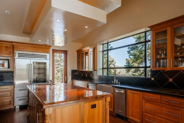 a living room with large window and furniture