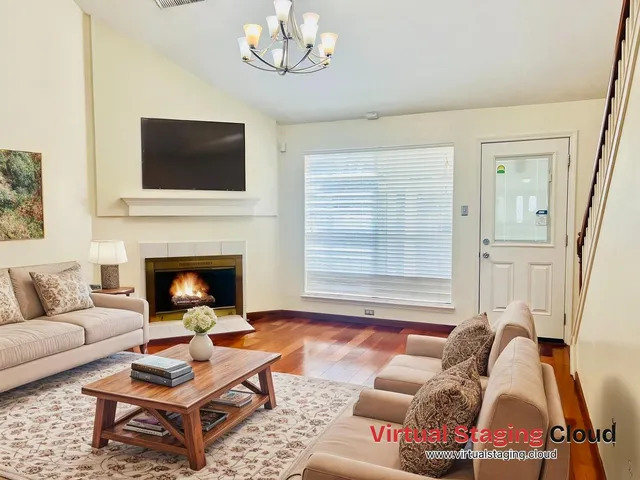 a living room with furniture a flat screen tv and a fireplace