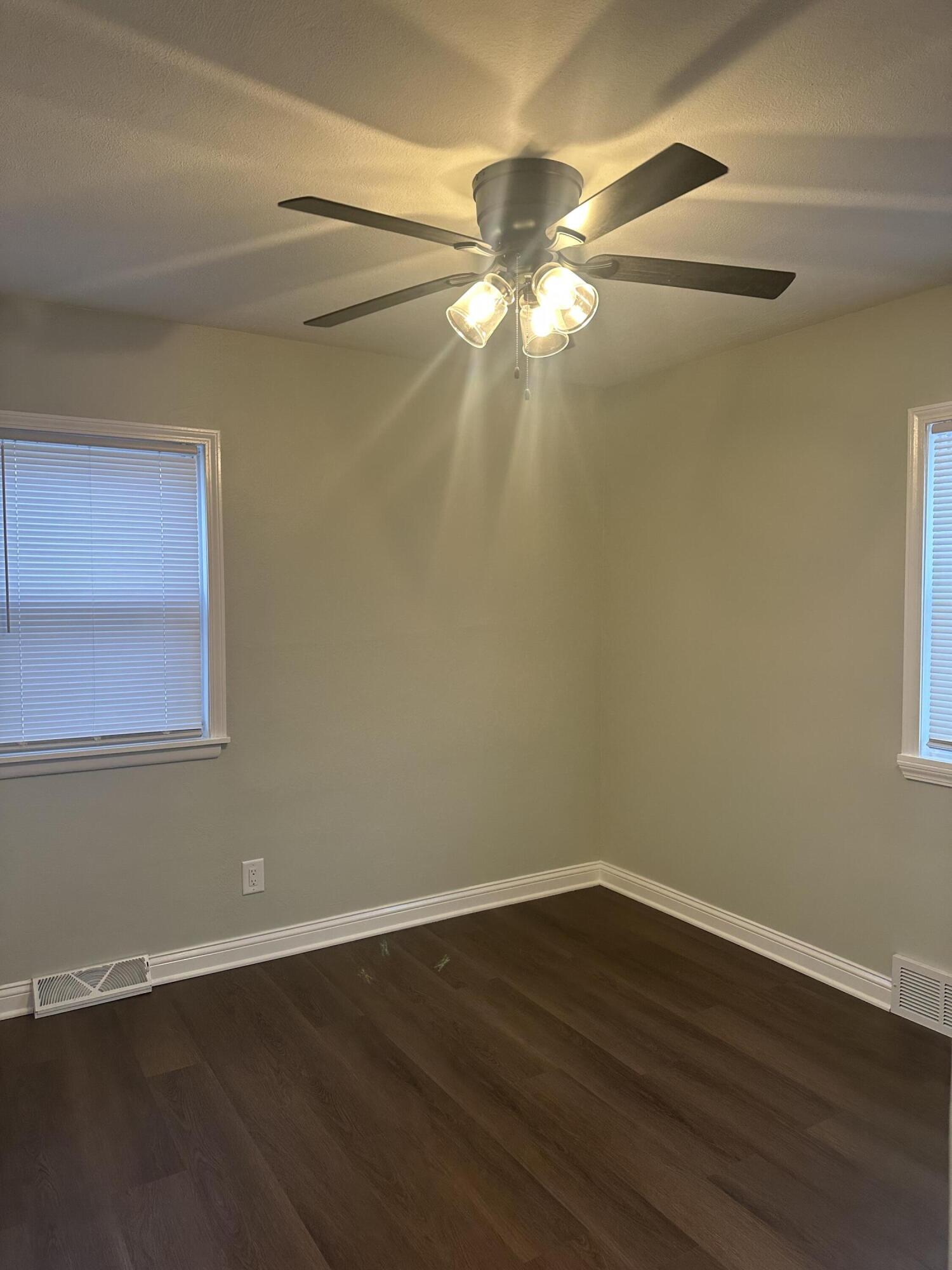 556 Gerry Street Gary, IN 46406 - Photo 11 of 21 a view of a room with wooden floor and fan