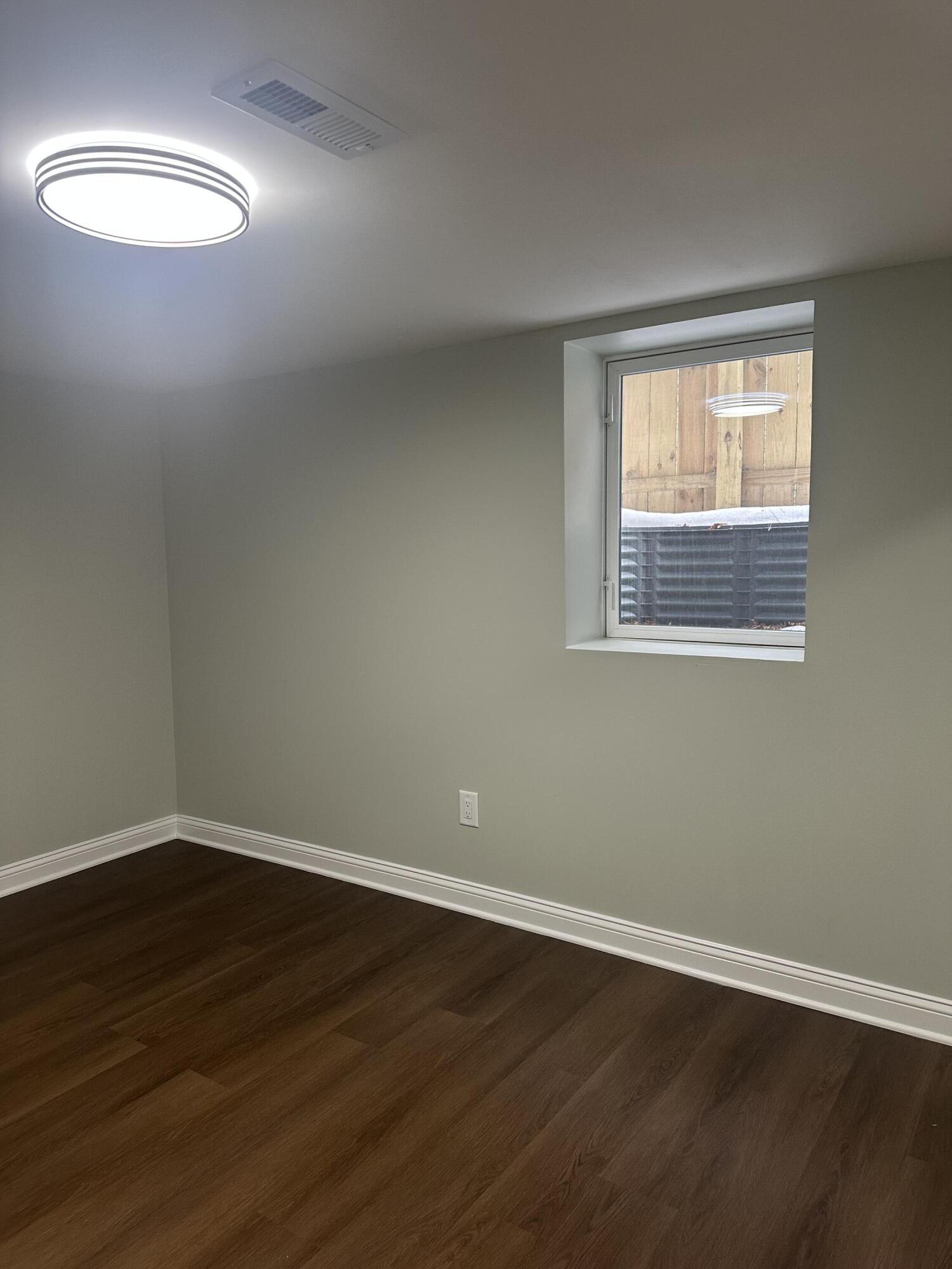 556 Gerry Street Gary, IN 46406 - Photo 13 of 21 a view of an empty room with wooden floor and a window