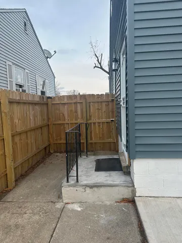 a view of a street with wooden fence