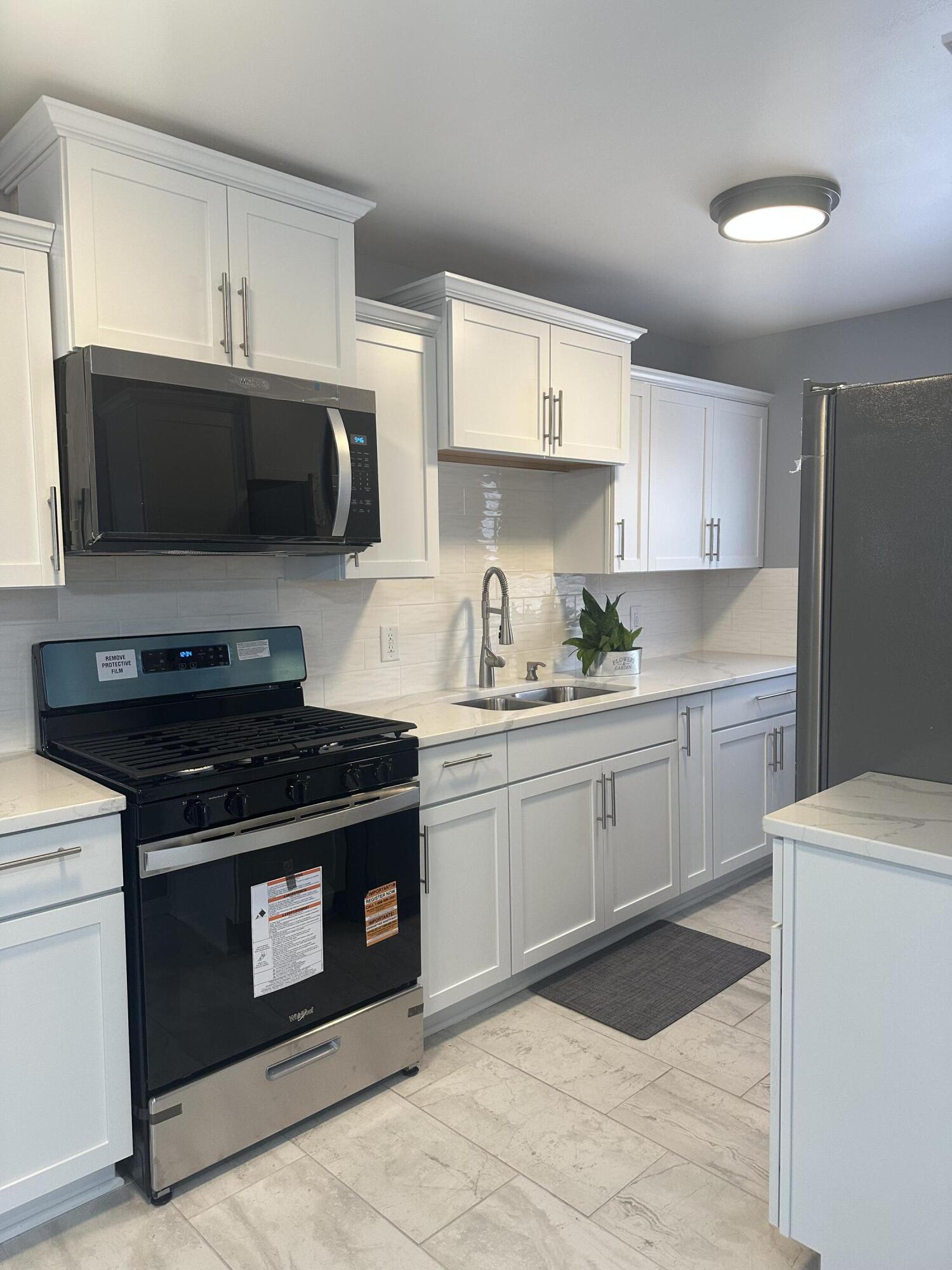 556 Gerry Street Gary, IN 46406 - Photo 4 of 21 a kitchen with a stove and a sink