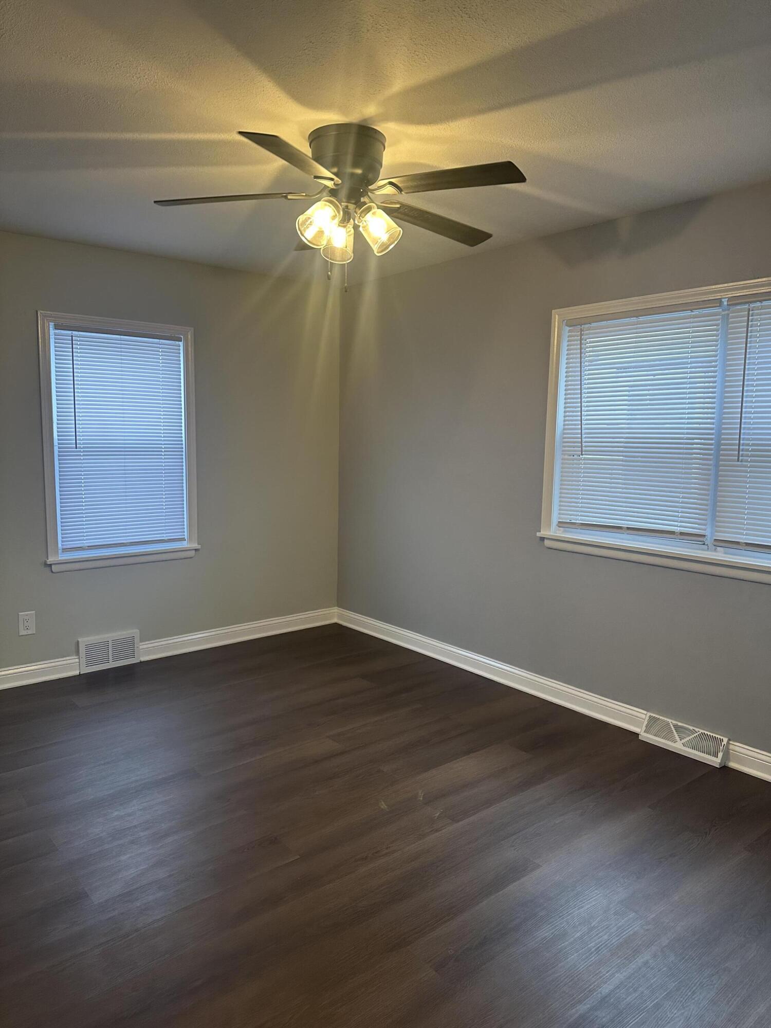 556 Gerry Street Gary, IN 46406 - Photo 9 of 21 a view of an empty room with wooden floor and a window