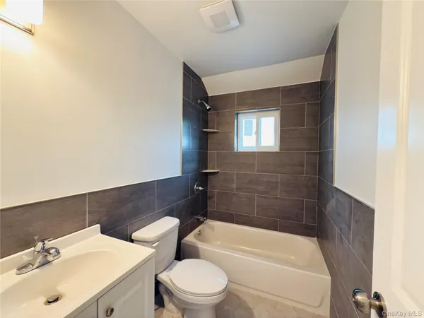 a bathroom with a sink a toilet and bathtub