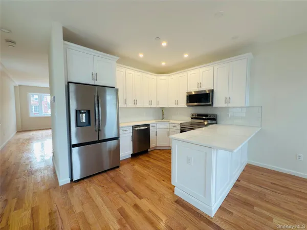 a kitchen with wooden cabinets and stainless steel appliances