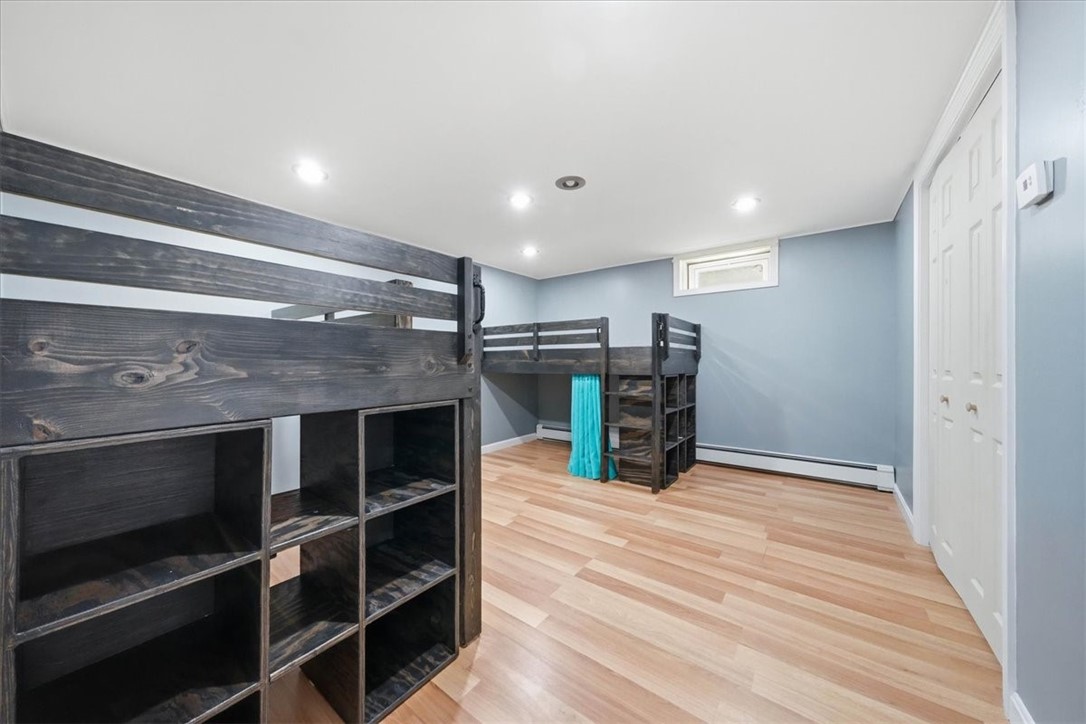214 Anan Wade Road Glocester, RI 02857 - Photo 28 of 50 An exceptionally roomy third bedroom with a private lower-level feel, abundant storage and convenient access to the home’s ground-level entrance.