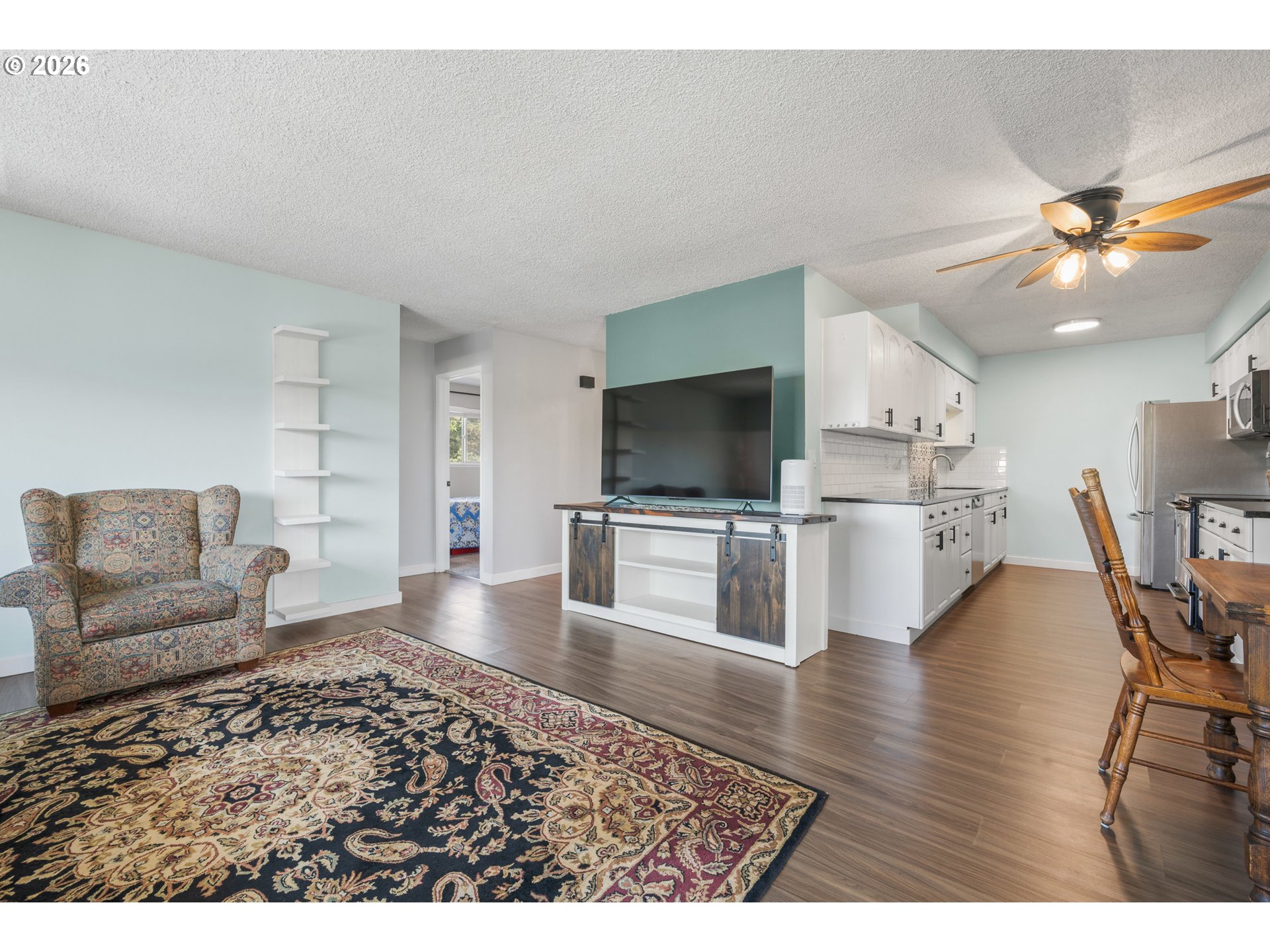 2727 Gateway Street, Unit 18 Springfield, OR 97477 - Photo 8 of 34 a living room with furniture and a flat screen tv