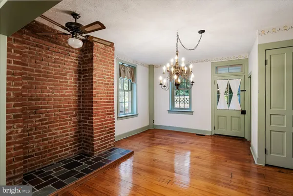 a view of an empty room and wooden floor
