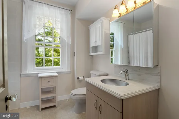 a bathroom with a sink and a window