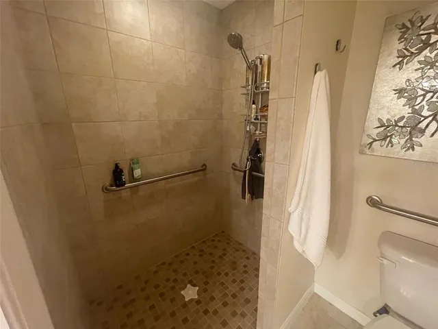 a bathroom with a shower and toilet