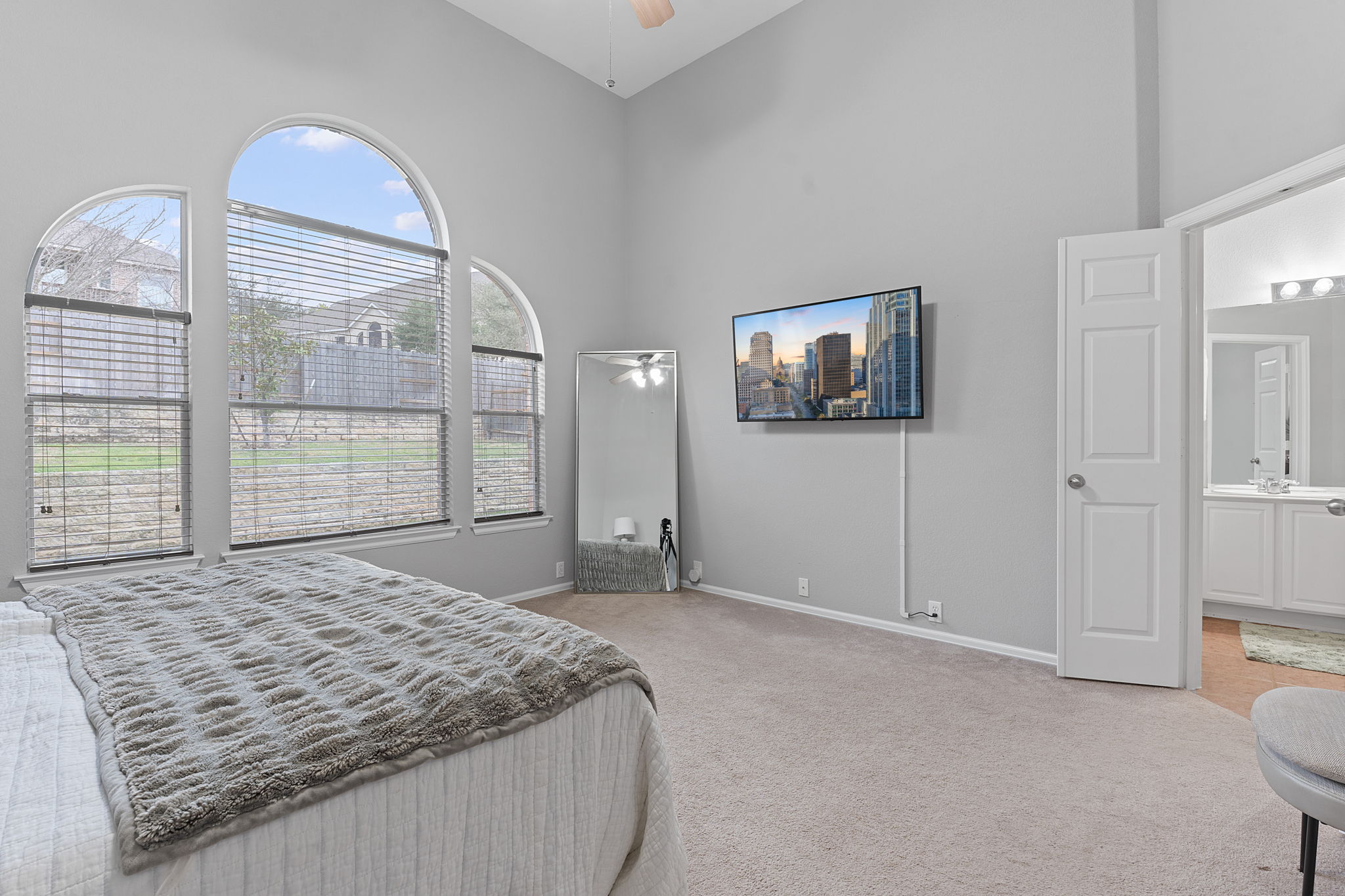 185 Mountain Laurel Way Austin, TX 78737 - Photo 13 of 33 a bedroom with a bed and a painting on the wall