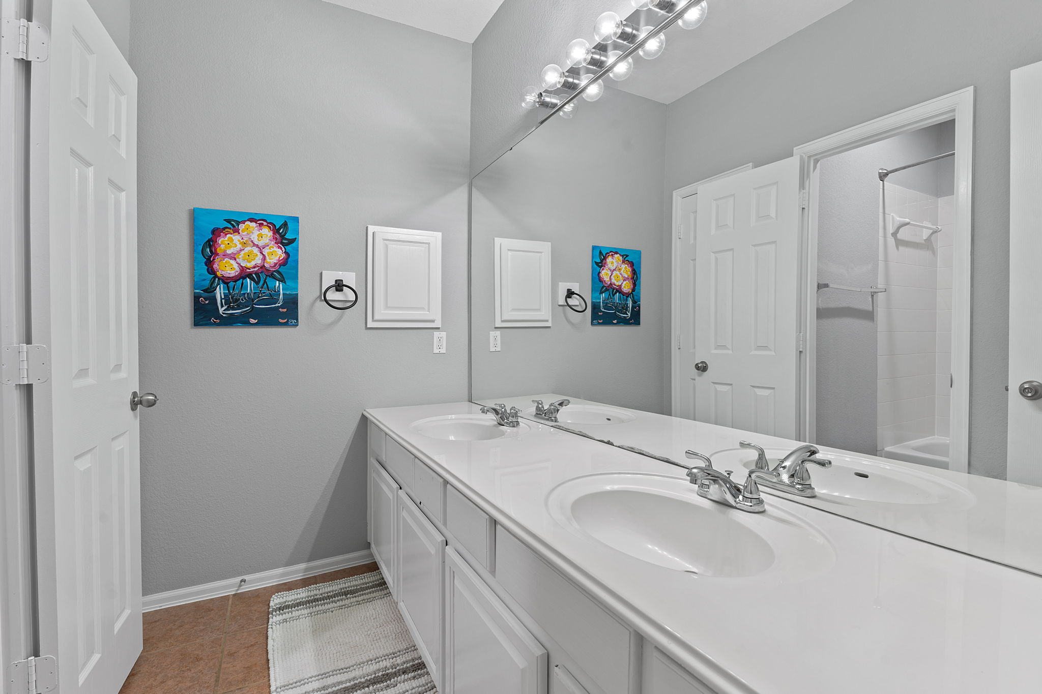 185 Mountain Laurel Way Austin, TX 78737 - Photo 21 of 33 a bathroom with a sinks a vanity a lamp and a mirror