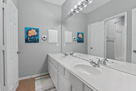 a bathroom with a sinks a vanity a lamp and a mirror