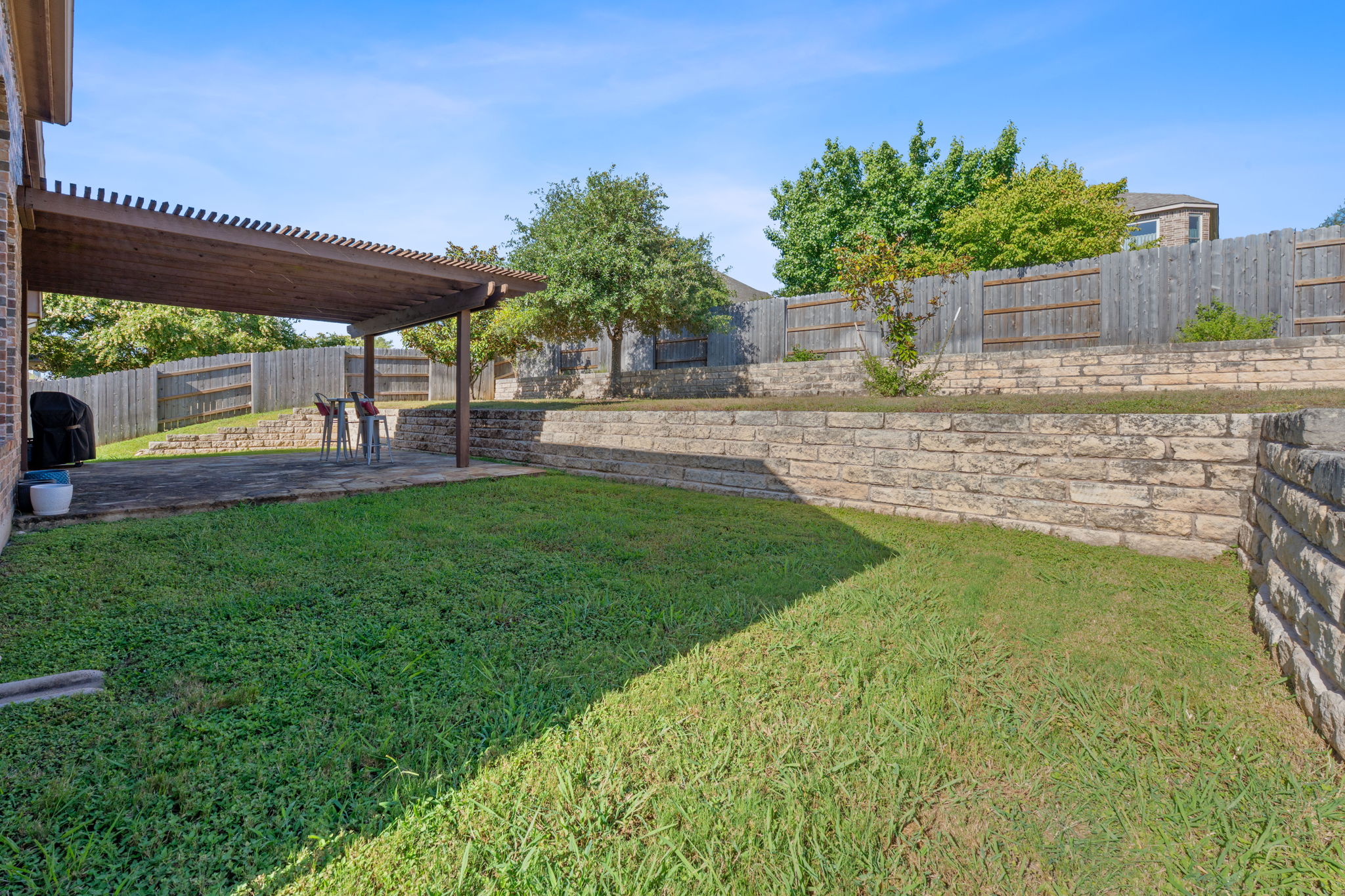 185 Mountain Laurel Way Austin, TX 78737 - Photo 24 of 33 a view of an house with backyard and a patio