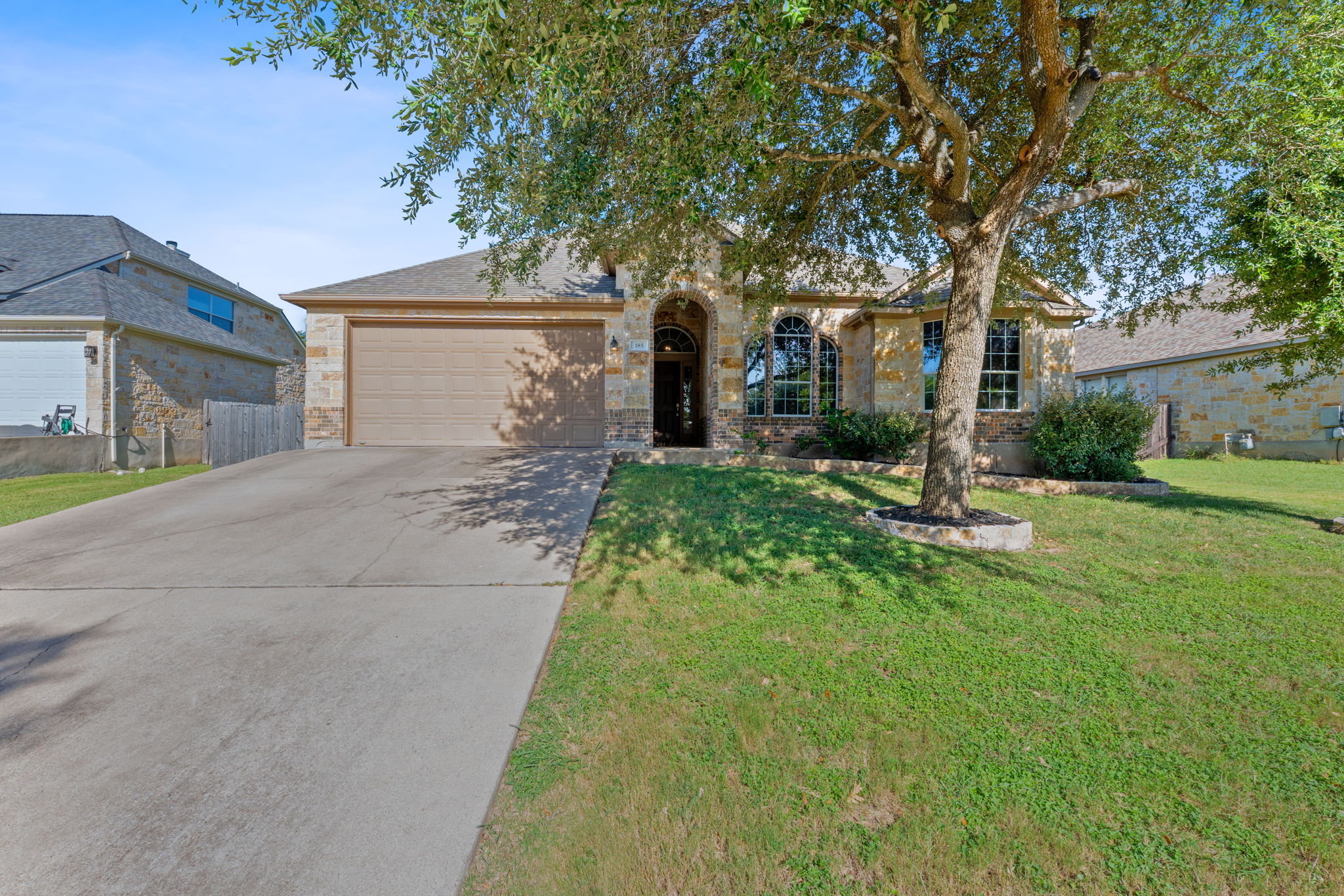 185 Mountain Laurel Way Austin, TX 78737 - Photo 32 of 33 a front view of a house with a yard and garage
