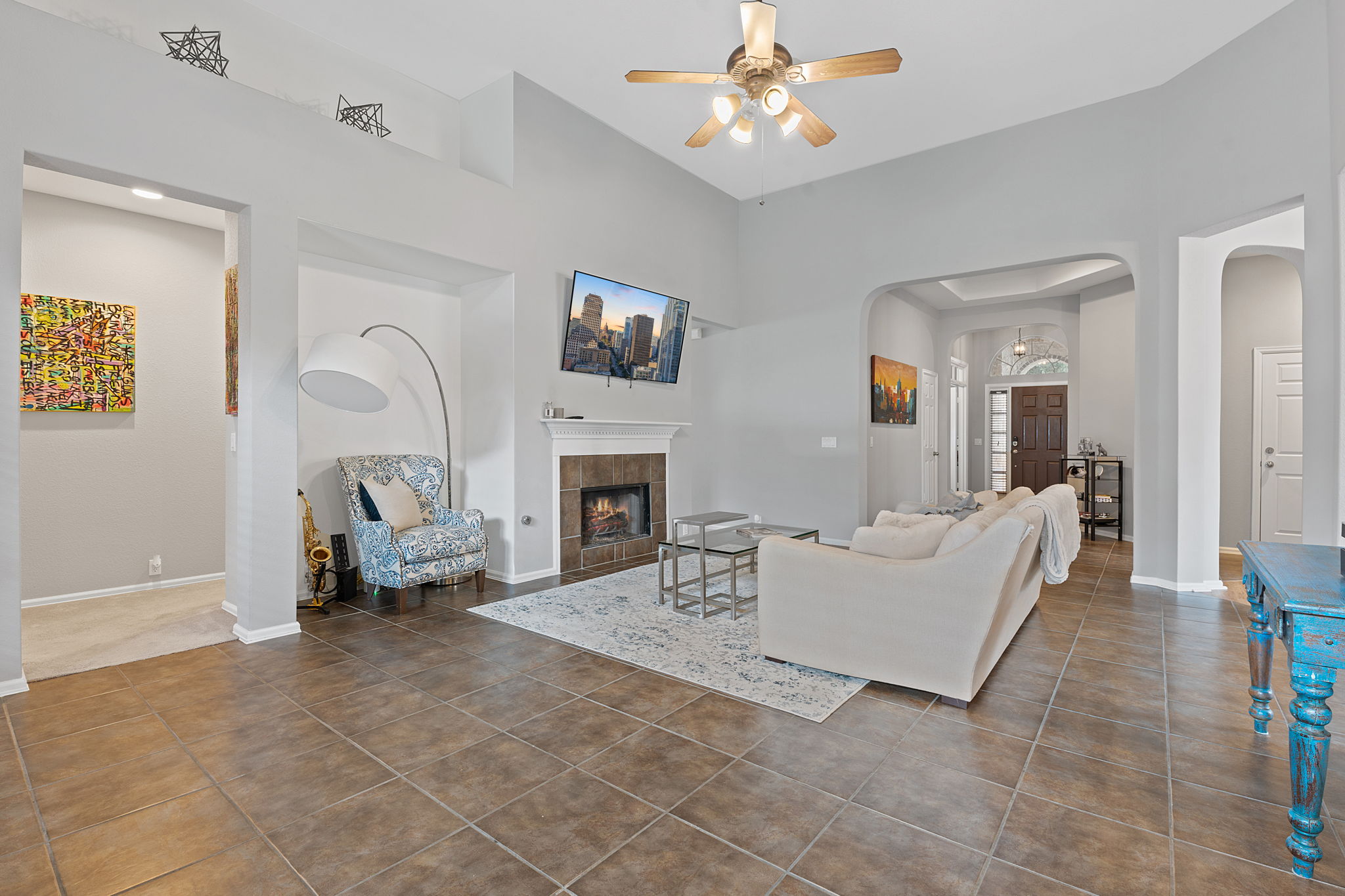 185 Mountain Laurel Way Austin, TX 78737 - Photo 3 of 33 a living room with furniture a fireplace and a flat screen tv