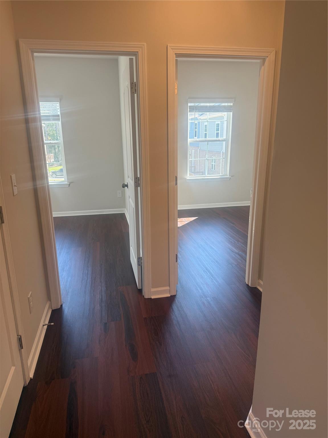 10016 Hemingway Place, Unit 22 Mint Hill, NC 28227 - Photo 11 of 16 an empty room with wooden floor and windows