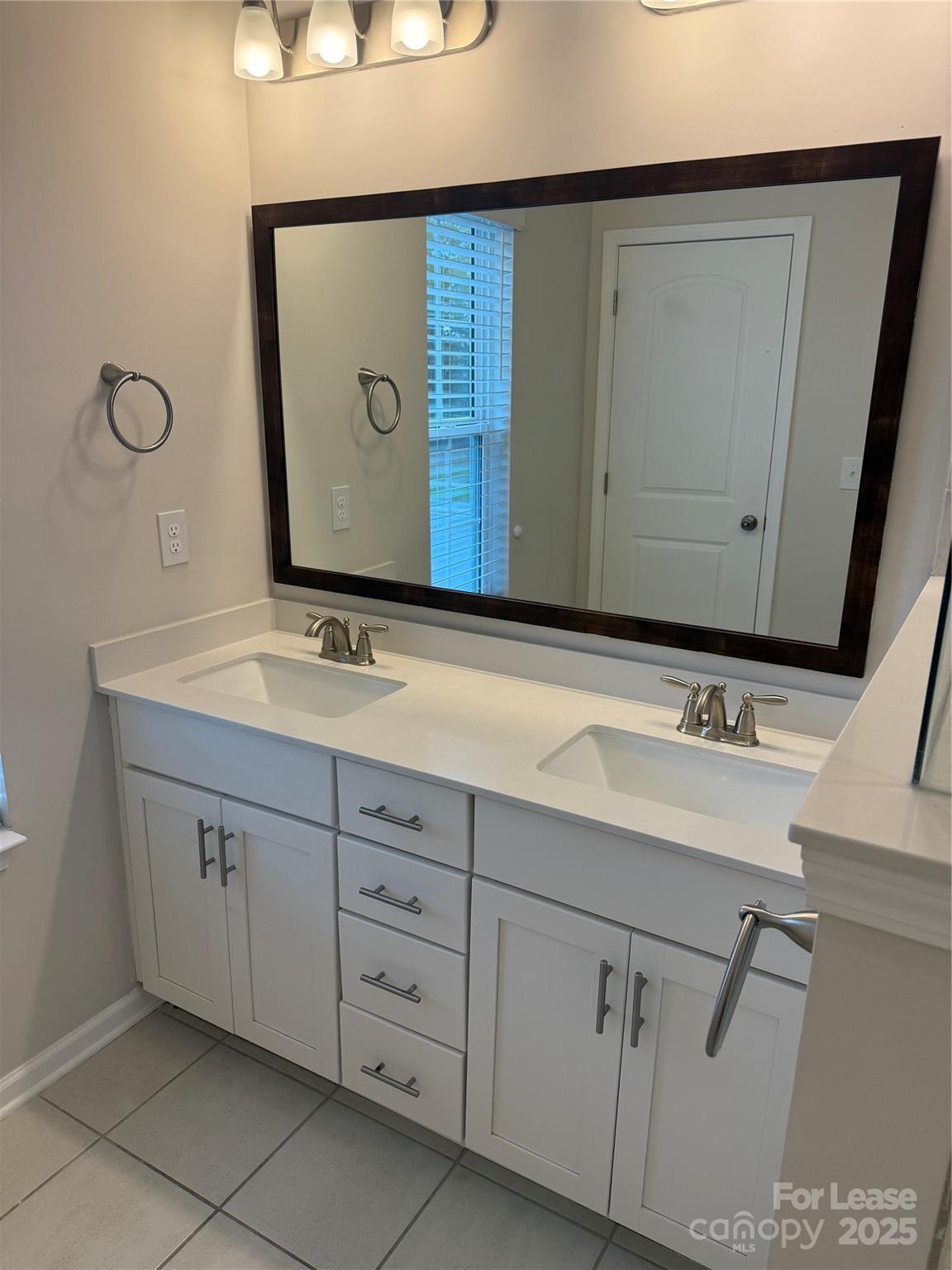 10016 Hemingway Place, Unit 22 Mint Hill, NC 28227 - Photo 14 of 16 a bathroom with a sink and mirror