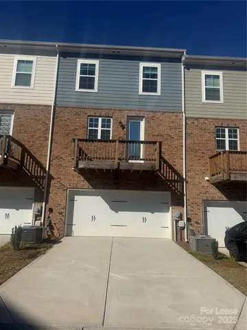 a front view of a house with parking space