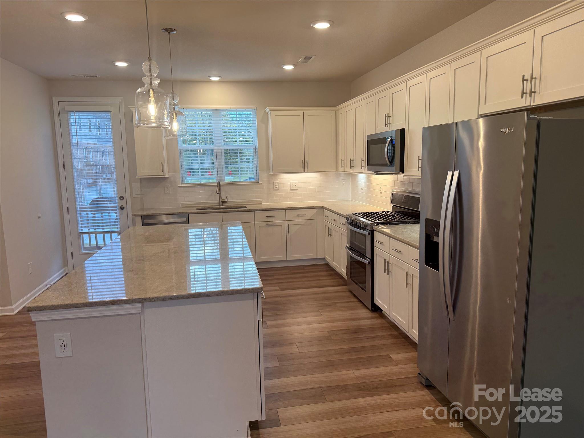 10016 Hemingway Place, Unit 22 Mint Hill, NC 28227 - Photo 7 of 16 a kitchen with stainless steel appliances a refrigerator sink and microwave