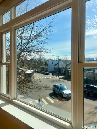 a view of a porch with a floor to ceiling window next to a yard
