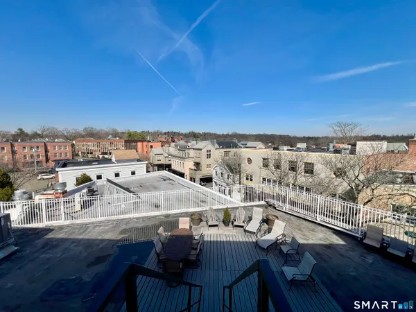 a view of roof deck with seating area