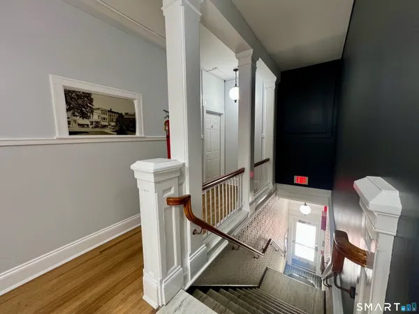 a view of an entryway with wooden floor