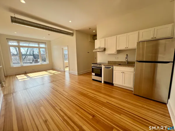 a kitchen with stainless steel appliances a refrigerator sink and cabinets